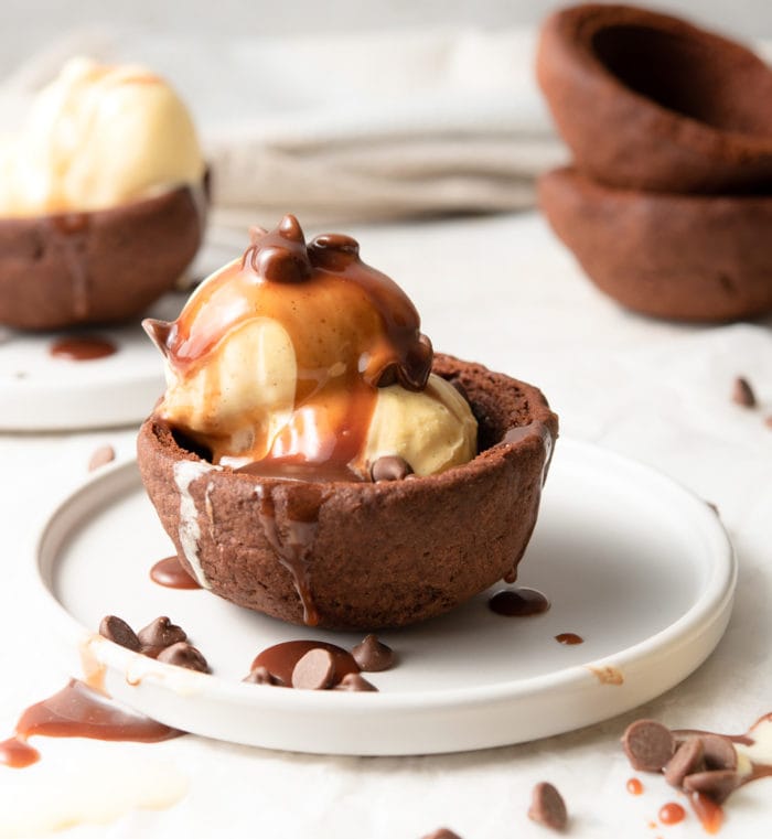 photo of ice cream in a chocolate cookie bowl topped with caramel sauce
