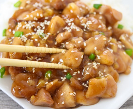 close-up photo of chopsticks grabbing a piece of Healthier Honey Sesame Chicken