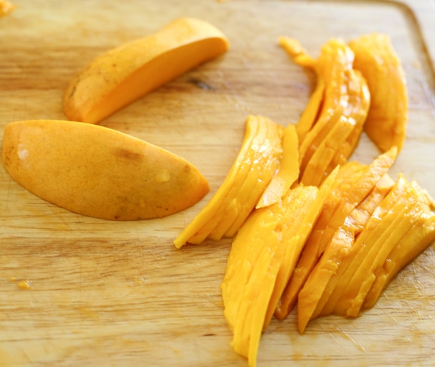 step-by-step photo showing how to thinly slice the mango
