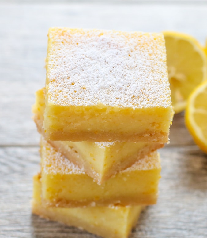 a close-up photo of a stack of four whole lemon bars