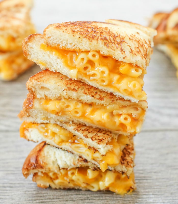 a close-up photo of a stack of grilled macaroni and cheese sandwiches