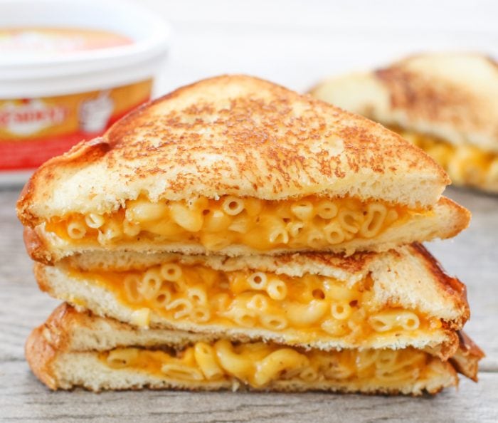 three grilled cheese sandwiches made with macaroni and cheese