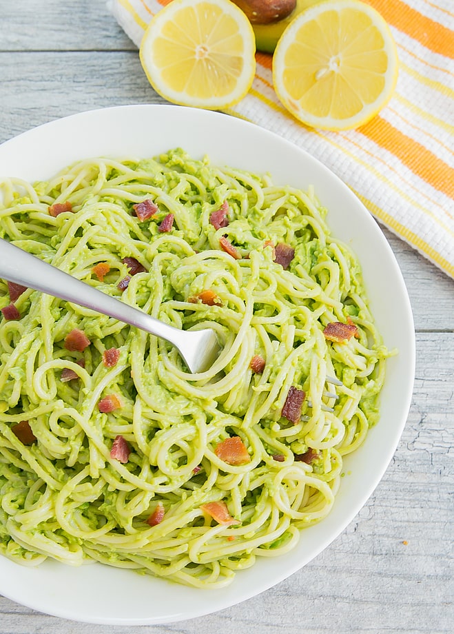 top-down photo of avocado pasta with a fork
