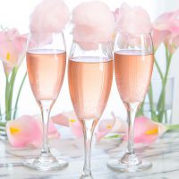 photo of glasses of champagne topped with cotton candy