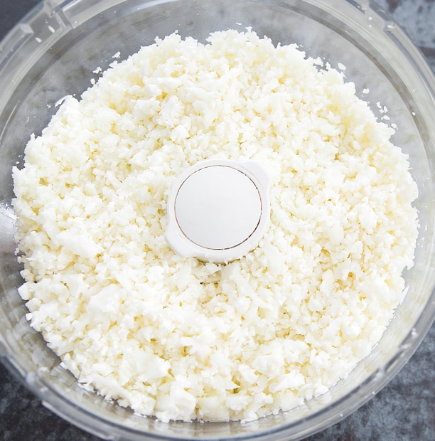 overhead photo of cauliflower rice in a food processor