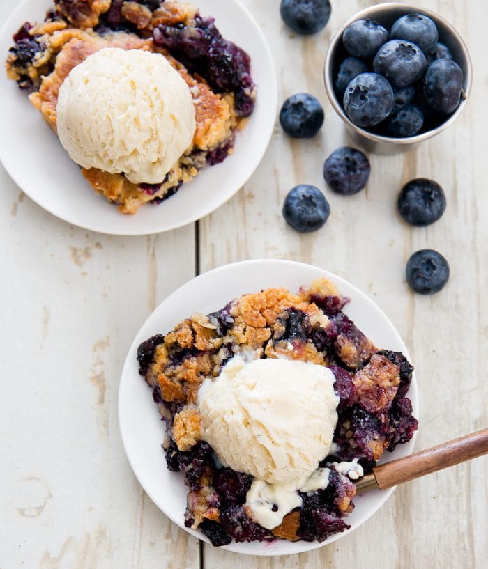 overhead photo of two servings of Blueberry Cobbler Dump Cake topped with ice cream