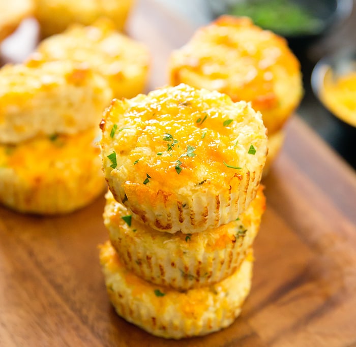 a close-up of a stack of cheesy cauliflower muffins