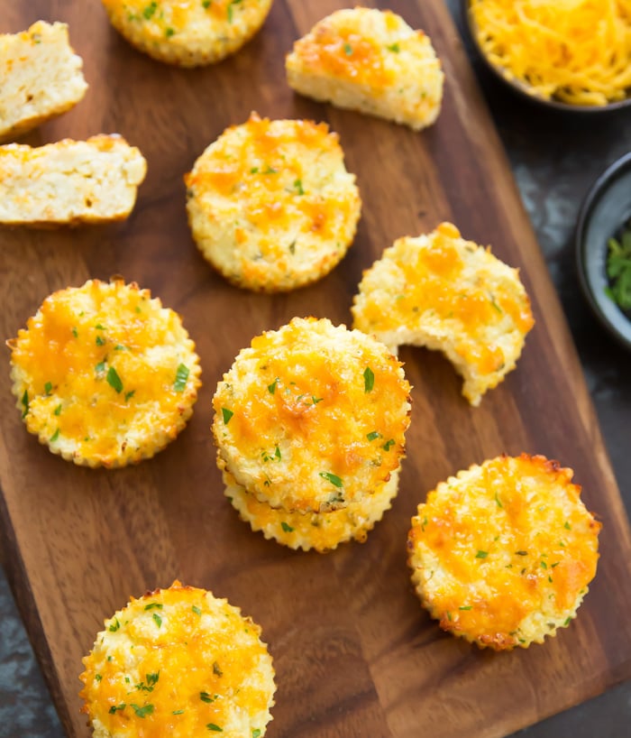 overhead shot of cheesy cauliflower muffins on a cutting board