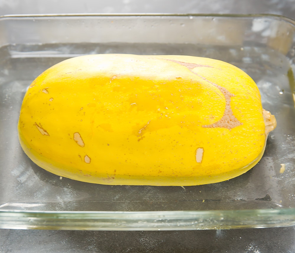 step by step photo of spaghetti squash half in a baking dish