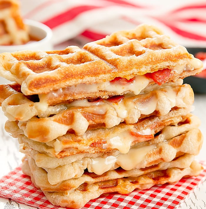 photo of Waffled Pepperoni Pizza Grilled Cheese sandwiches stacked on each other