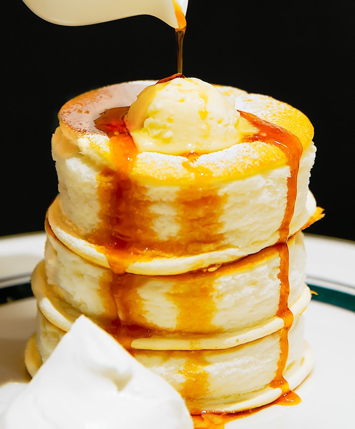 Gram Cafe Premium Pancakes with syrup being poured over the top