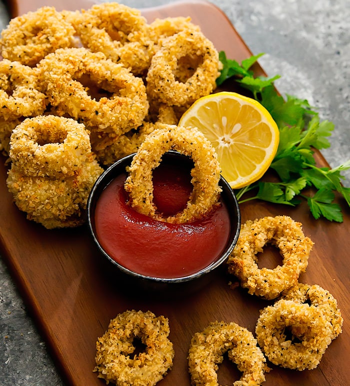 photo of a baked calamari being dipped in sauce