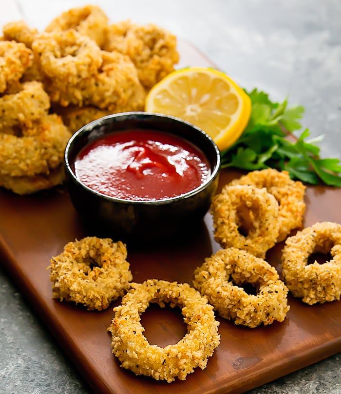 photo of baked calamari on a platter with dipping sauce