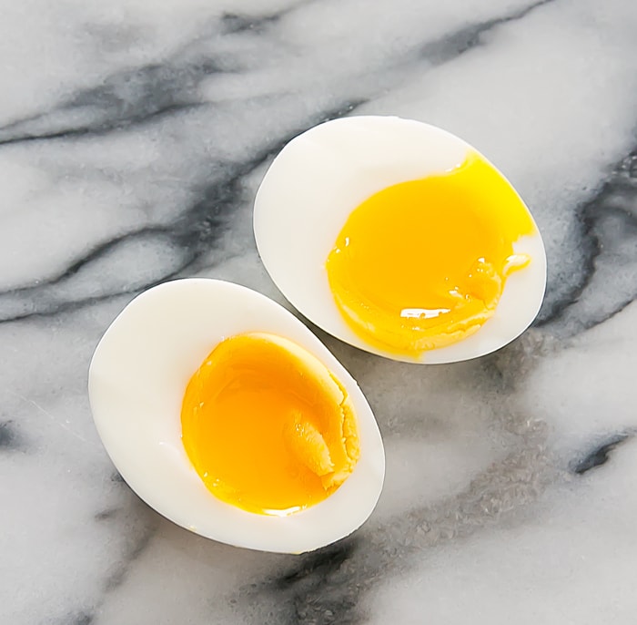overhead photo of a soft-boiled egg sliced in half