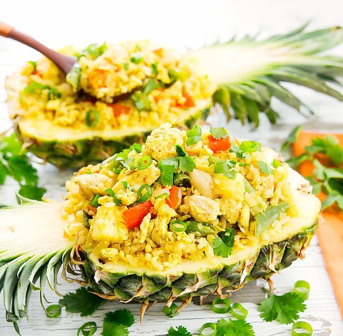 photo of Thai pineapple cauliflower fried rice served in two pineapple shells