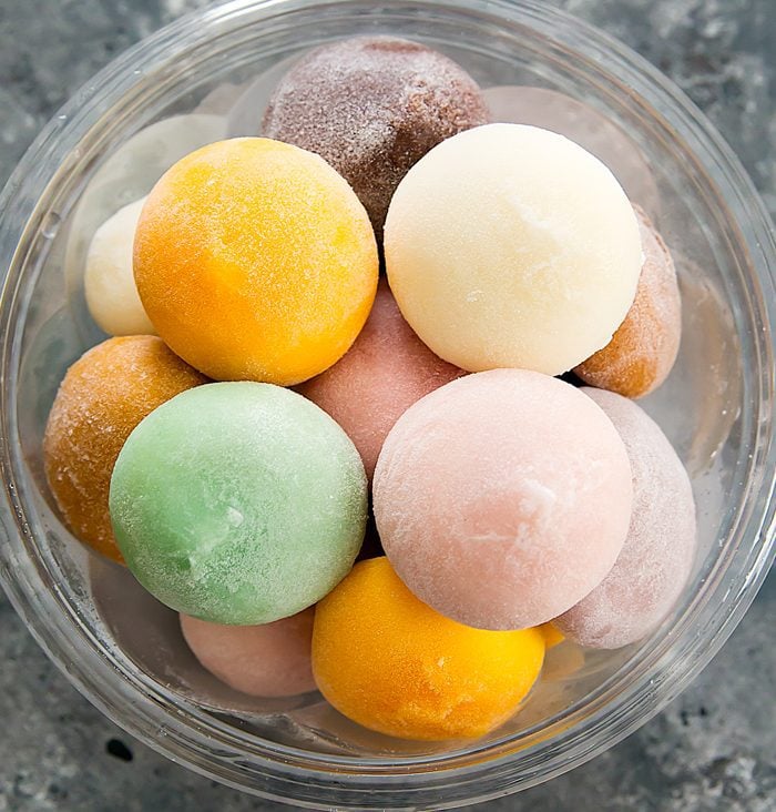 overhead photo of different kinds of mochi ice cream flavors in a bowl