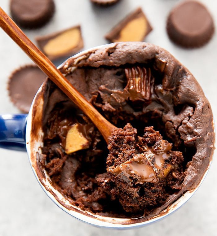 overhead photo of a spoon digging into a Chocolate Peanut Butter Cup Mug Cake
