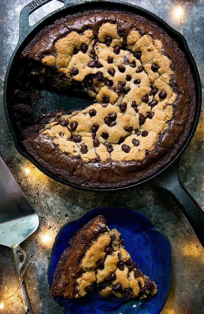 Deep Dish Chocolate Chip Cookie Skillet Brownie with a slice cut out