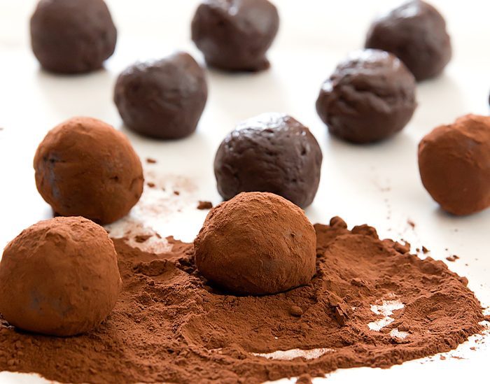 photo showing how to roll the balls in the cocoa powder