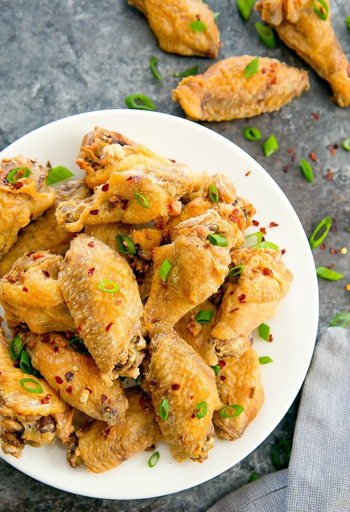 overhead photo of baked salt and pepper wings on a white plate