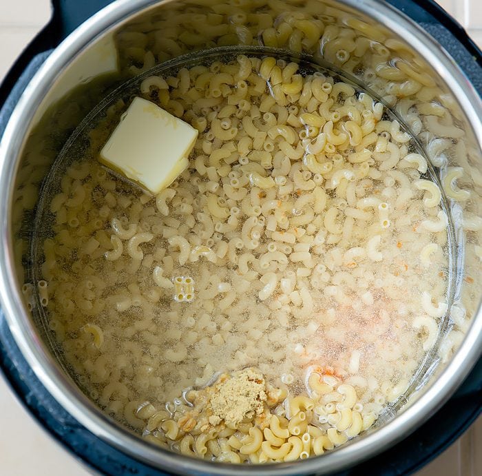 photo of pasta, butter, water, and seasonins inside an instant pot
