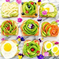 overhead photo of different kinds of avocado toasts