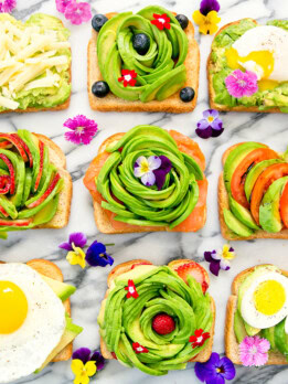 overhead photo of different kinds of avocado toasts