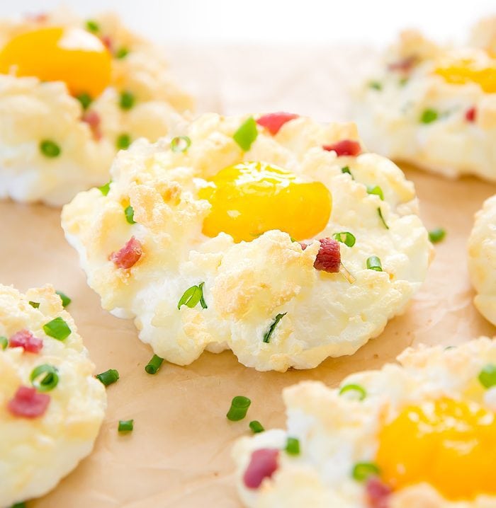 close-up photo of egg cloud garnished with bacon and chives