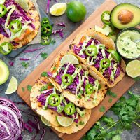 overhead photo of fish tacos with avocado sauce