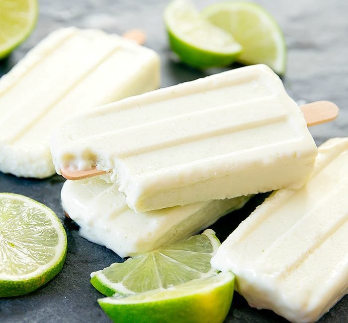 Creamy Lime Coconut Ice Pop with a bite taken out of it  Lime Coconut Ice Pops lime coconut ice pops a 700x651