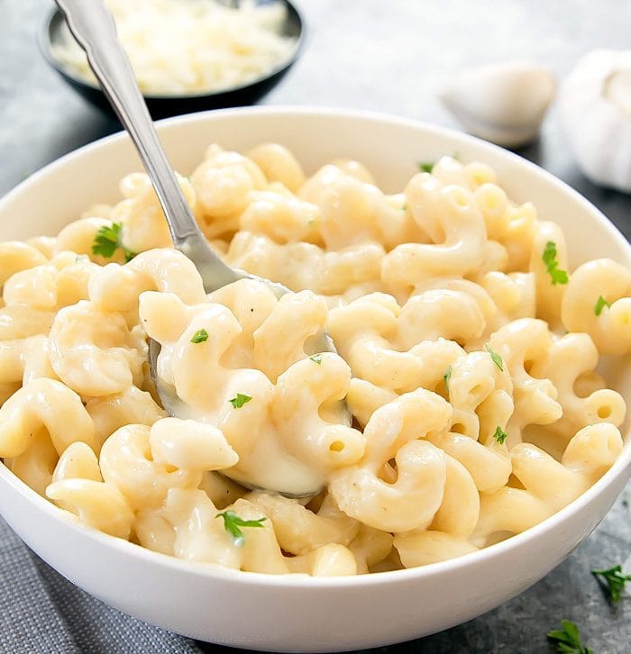 close-up photo of a spoon in a bowl of garlic parmesan macaroni and cheese
