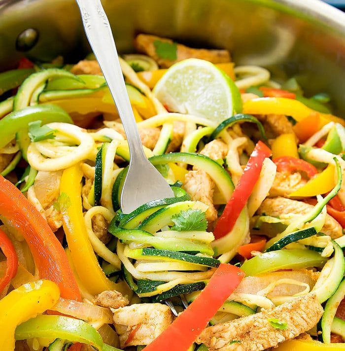 close-up photo of a fork twirling zucchini noodles