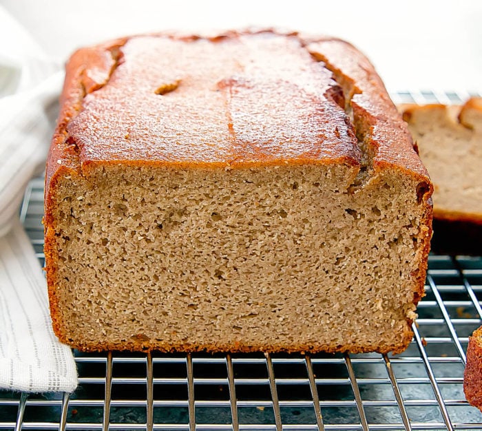 a close-up photo of a sliced loaf of flourless banana bread
