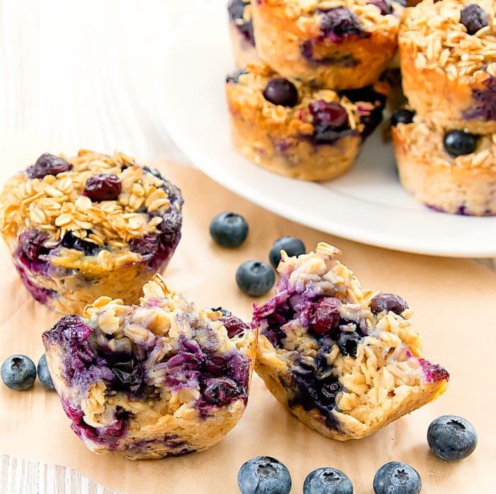 a close-up of a baked blueberry oatmeal cup sliced in half 