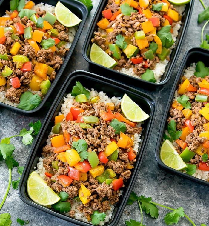 overhead photo of four Fajita Bowls with Cauliflower Rice in meal prep containers