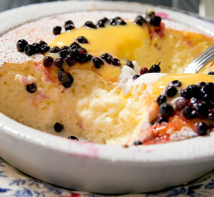 close-up photo of Dutch Baby Soufflé Pancake, Huckleberry, Lemon Curd, Vanilla Chantilly