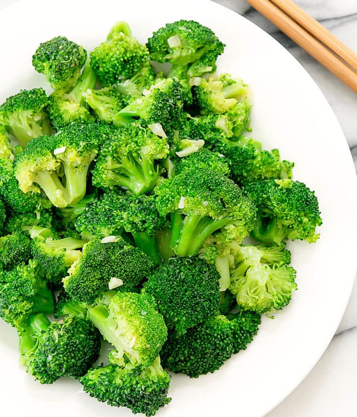 garlic broccoli stir fry on a white serving plate