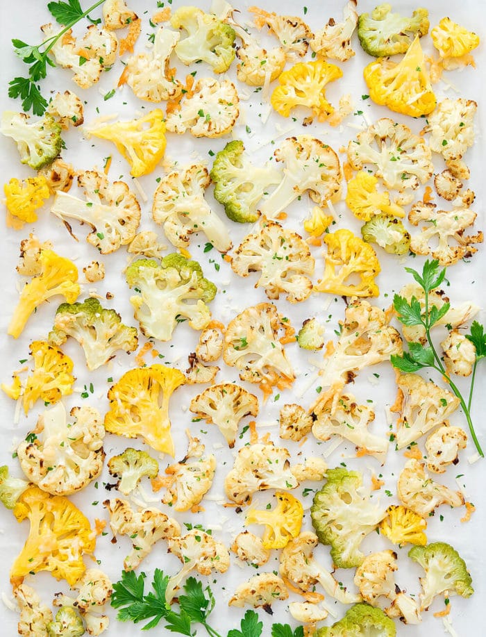overhead view of sheet pan with parmesan roasted orange, green and white cauliflower