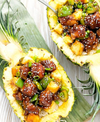 overhead photo of two pineapple bowls with teriyaki chicken