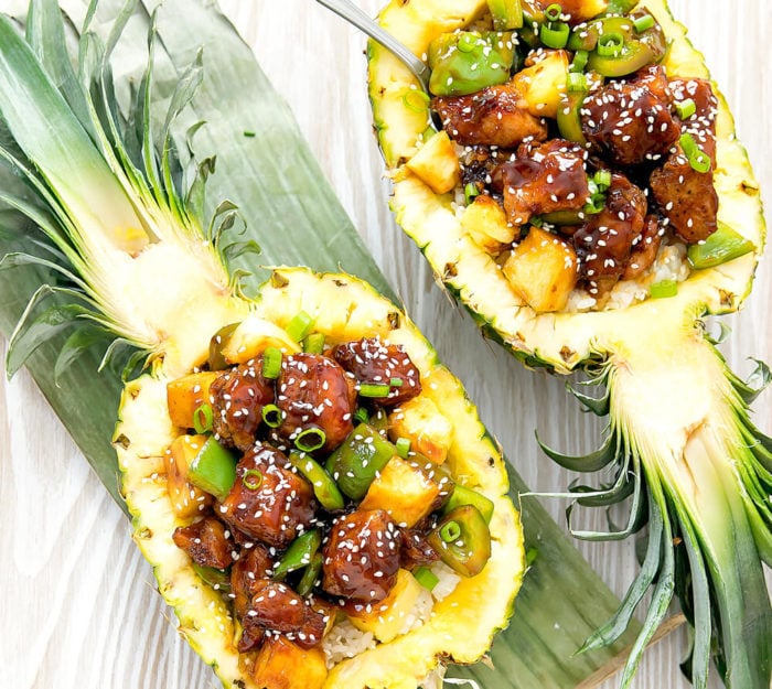 overhead photo of two pineapple bowls with teriyaki chicken
