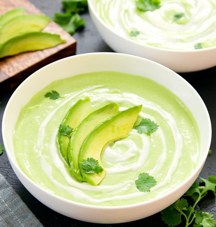 close-up of Cream of Avocado Soup garnished with fresh avocado slices