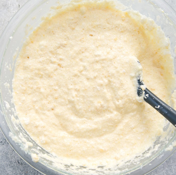 Prep photo showing whipped egg whites folded into cauliflower bread batter