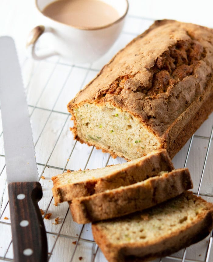 photo of a loaf of Zucchini Bread with three slices