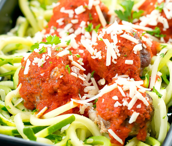 close-up photo of keto meatballs with sauce and zucchini noodles