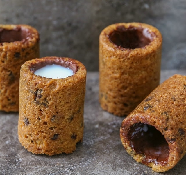 photo of four cookie shot glasses with one filled with milk