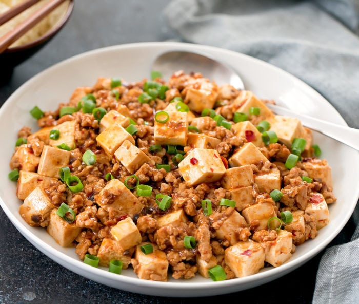 photo of Mapo Tofu in a bowl with a serving spoon