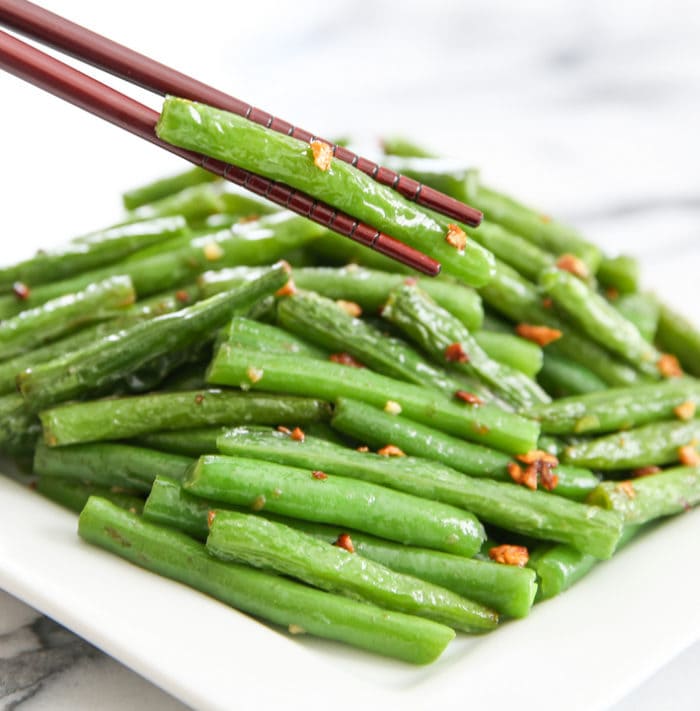 Chopstick holding chinese garlic green bean