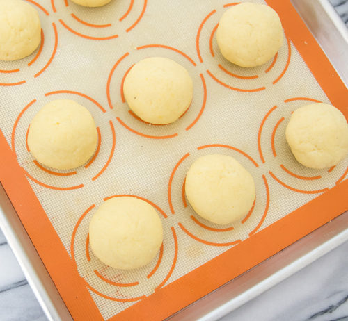 photo of a the dough balls on a baking sheet