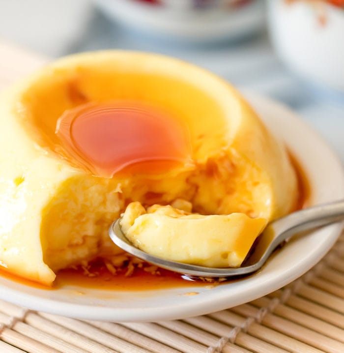 close-up photo of a custard pudding with a spoon