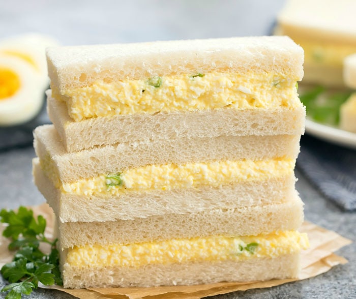 close-up photo of a stack of egg salad sandwiches